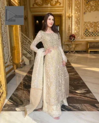 Bringing in the Nikah spirit with some flowers. Exquisite nikkah long shirt dress in pale green colour with silver pearl, sequin, kora, dabka, tilla, Zardozi, and Kundan embroidery accents. The embroidery on the whole length of the sleeves is done in flowery designs. This masterpiece is extremely special and endearing because of the boat shape neckline. The inner blouse of the beautiful outfit is embellished with embroidery. Also, the trousers makes it a wonderful match for the dupatta. In order to balance the entire ensemble, it is arranged with a dupatta.