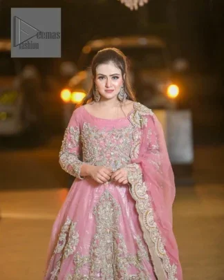 DeemasFashion presents this wedding outfit which is an embellished masterpiece that wins everyone’s hearts at the very first glance with its charm and elegance. The Maxi in the Pink colour has laden with Golden embroidery which makes this attire a head-turning masterpiece. Further, the round neckline is fully embellished with tilla, dabka, kora, Kundan, and pearls that is giving it a magical look. The fullsleeves style makes this outfit a little attractive but super charming. Complete this article with a dupatta, framed with a four-sided border.