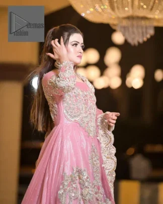 DeemasFashion presents this wedding outfit which is an embellished masterpiece that wins everyone’s hearts at the very first glance with its charm and elegance. The Maxi in the Pink colour has laden with Golden embroidery which makes this attire a head-turning masterpiece. Further, the round neckline is fully embellished with tilla, dabka, kora, Kundan, and pearls that is giving it a magical look. The fullsleeves style makes this outfit a little attractive but super charming. Complete this article with a dupatta, framed with a four-sided border.