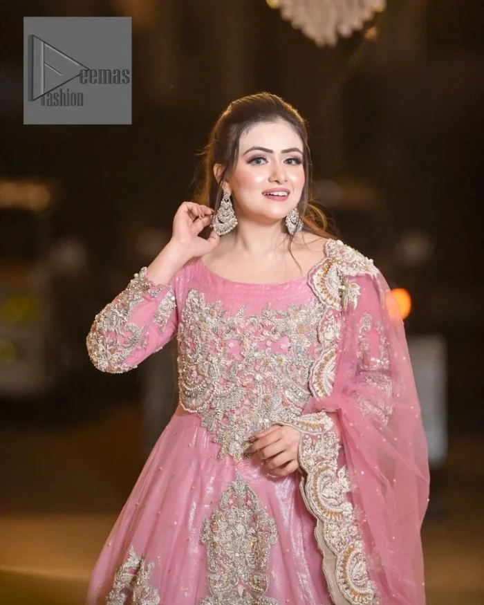 DeemasFashion presents this wedding outfit which is an embellished masterpiece that wins everyone’s hearts at the very first glance with its charm and elegance. The Maxi in the Pink colour has laden with Golden embroidery which makes this attire a head-turning masterpiece. Further, the round neckline is fully embellished with tilla, dabka, kora, Kundan, and pearls that is giving it a magical look. The fullsleeves style makes this outfit a little attractive but super charming. Complete this article with a dupatta, framed with a four-sided border.