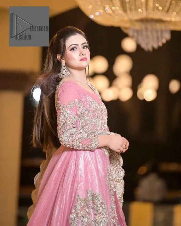 DeemasFashion presents this wedding outfit which is an embellished masterpiece that wins everyone’s hearts at the very first glance with its charm and elegance. The Maxi in the Pink colour has laden with Golden embroidery which makes this attire a head-turning masterpiece. Further, the round neckline is fully embellished with tilla, dabka, kora, Kundan, and pearls that is giving it a magical look. The fullsleeves style makes this outfit a little attractive but super charming. Complete this article with a dupatta, framed with a four-sided border.