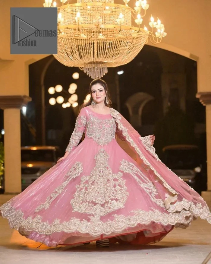 DeemasFashion presents this wedding outfit which is an embellished masterpiece that wins everyone’s hearts at the very first glance with its charm and elegance. The Maxi in the Pink colour has laden with Golden embroidery which makes this attire a head-turning masterpiece. Further, the round neckline is fully embellished with tilla, dabka, kora, Kundan, and pearls that is giving it a magical look. The fullsleeves style makes this outfit a little attractive but super charming. Complete this article with a dupatta, framed with a four-sided border.