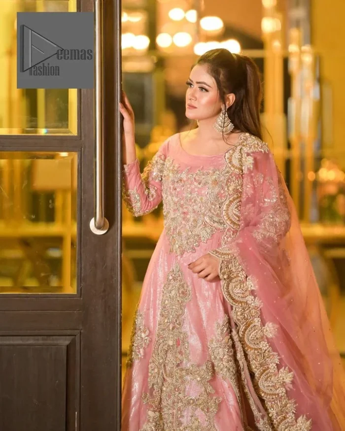 DeemasFashion presents this wedding outfit which is an embellished masterpiece that wins everyone’s hearts at the very first glance with its charm and elegance. The Maxi in the Pink colour has laden with Golden embroidery which makes this attire a head-turning masterpiece. Further, the round neckline is fully embellished with tilla, dabka, kora, Kundan, and pearls that is giving it a magical look. The fullsleeves style makes this outfit a little attractive but super charming. Complete this article with a dupatta, framed with a four-sided border.