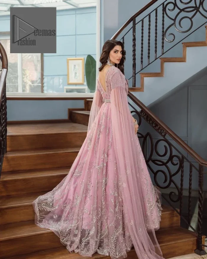 DeemasFashion presents this wedding outfit which is an embellished masterpiece that wins everyone’s hearts at the very first glance with its charm and elegance. The Maxi in the Pink colour has laden with Silver embroidery which makes this attire a head-turning masterpiece. Further, the v-neckline is fully embellished with tilla, dabka, kora, Kundan, and pearls that is giving it a magical look. The hanging sleeves style makes this outfit a little attractive but super charming. Complete this article with a dupatta, framed with a four-sided border.