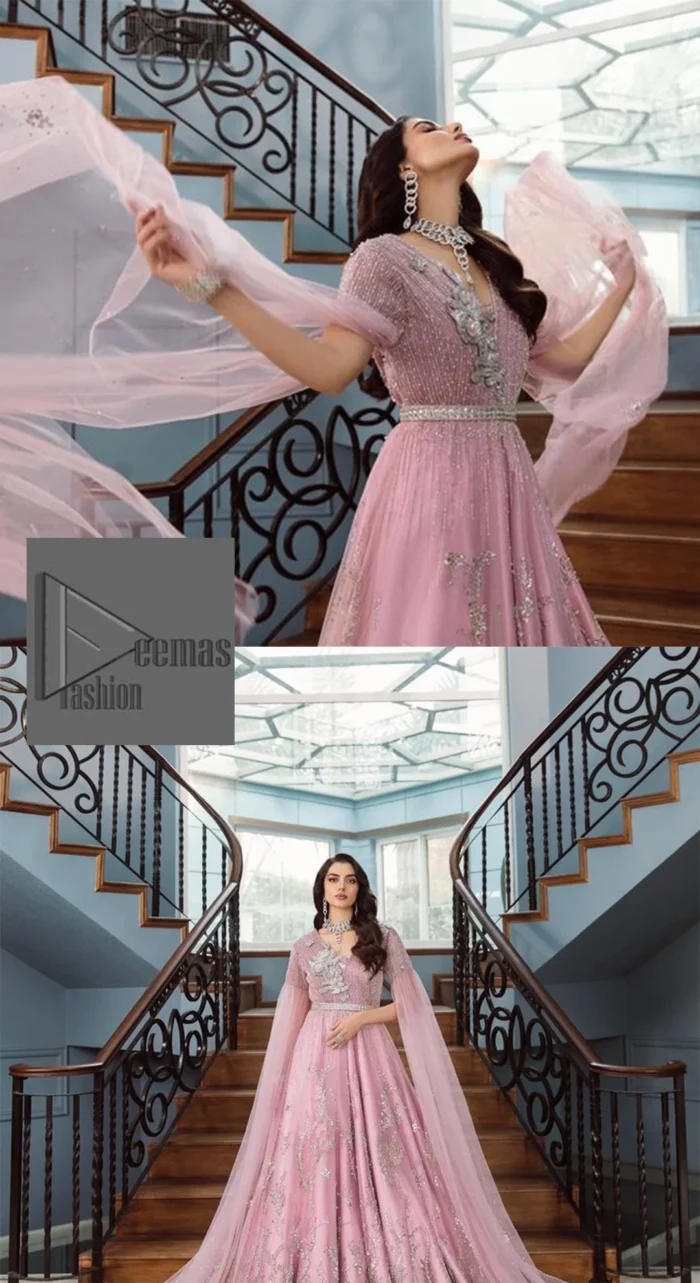 DeemasFashion presents this wedding outfit which is an embellished masterpiece that wins everyone’s hearts at the very first glance with its charm and elegance. The Maxi in the Pink colour has laden with Silver embroidery which makes this attire a head-turning masterpiece. Further, the v-neckline is fully embellished with tilla, dabka, kora, Kundan, and pearls that is giving it a magical look. The hanging sleeves style makes this outfit a little attractive but super charming. Complete this article with a dupatta, framed with a four-sided border.