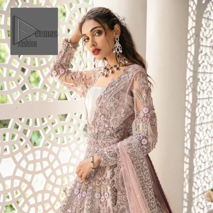 Deemas Fashion tea pink dress is an assortment of celebrations and rituals where luxury plays a significant role. This fully embellished traditional dress makes minimal use of jewelry as its sleeves, back train and huge flare is perfectly enriched with embroidery, so no element of the dress or bride herself is without decoration. 