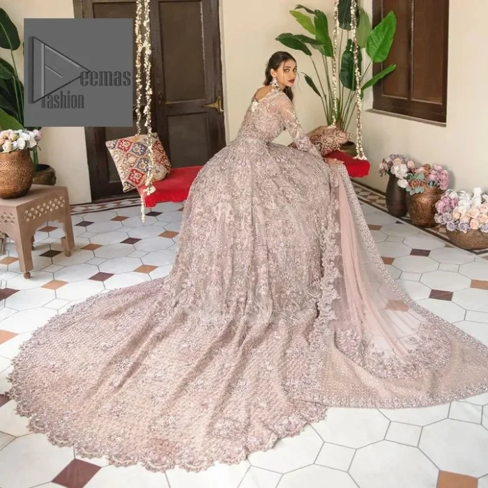 Deemas Fashion tea pink dress is an assortment of celebrations and rituals where luxury plays a significant role. This fully embellished traditional dress makes minimal use of jewelry as its sleeves, back train and huge flare is perfectly enriched with embroidery, so no element of the dress or bride herself is without decoration. 