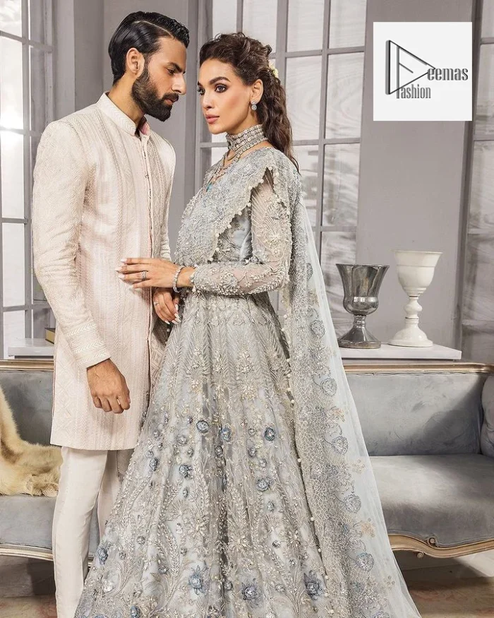 The full sleeves are covered with attractive geometrical patterns. Further, the V-shaped neckline is beautifully decorated with tilla, dabka, kora, Kundan and the real magic of Zardozi. The following maxi is further intensified with multiple colour embroidery and matching embellishments to give you a royal touch.