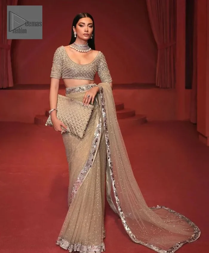 It is paired up with a saree in the same color having sequins spray all over to make a true statement.