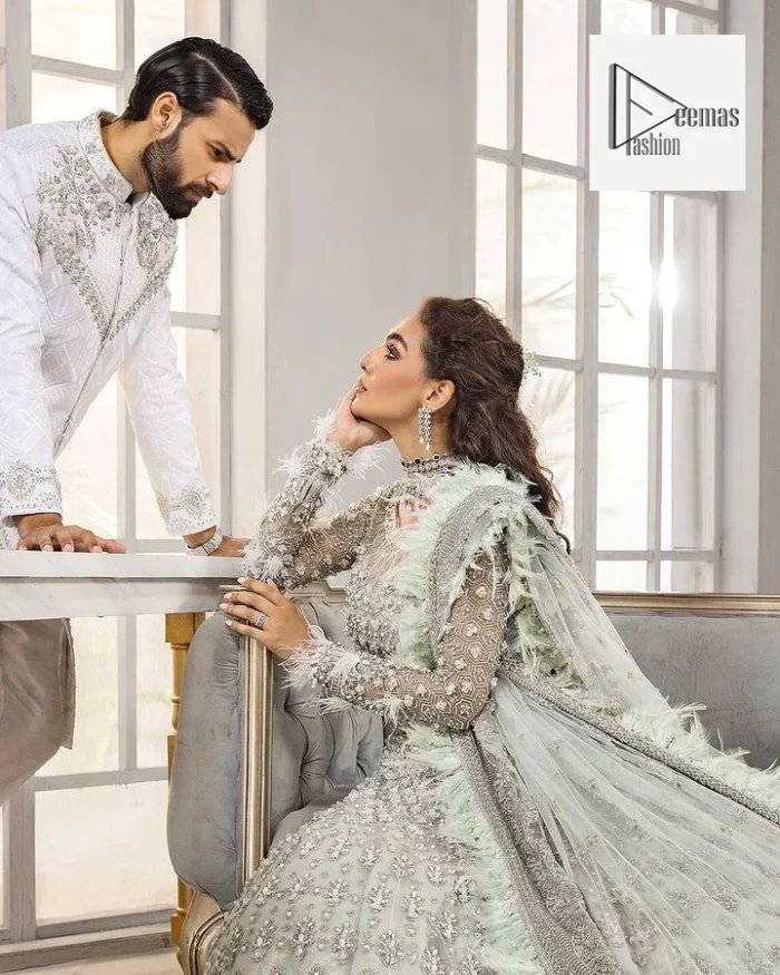 The lehenga is also embellished with beautiful zari work. Complete this article with a dupatta framed with four-sided embellished borders and floral motifs all over.