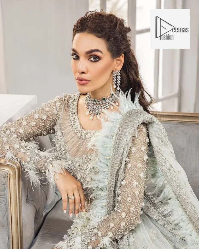 The lehenga is also embellished with beautiful zari work. Complete this article with a dupatta framed with four-sided embellished borders and floral motifs all over.