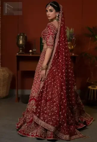 Stand out at your reception in a very special maroon outfit. This dress is not like any other – it's a super unique blouse lehenga.