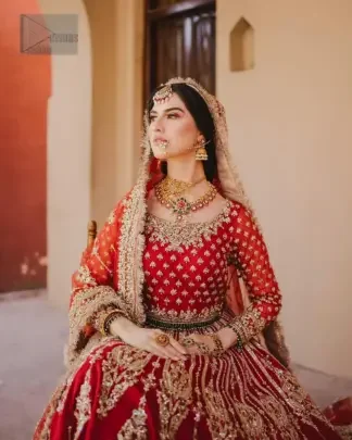 This unique red dress is a masterpiece of design, crafted with light golden and light antique shades of embroidery to capture the essence of your special day with unparalleled style. A fusion of modern and classic elements of fashion lehenga make this epitome of beauty, this reception dress offers a truly distinctive look