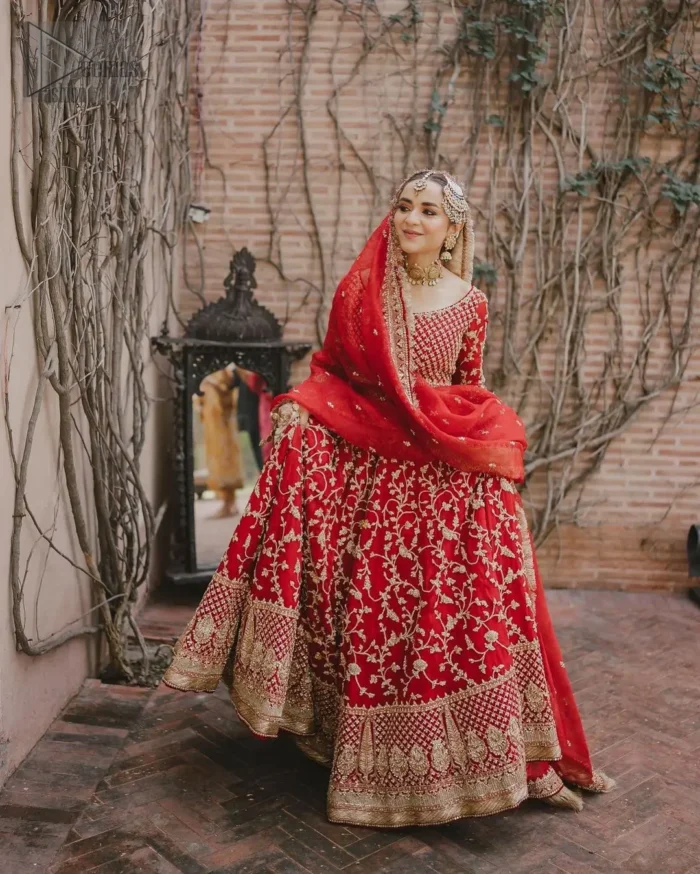 This unique dress is a masterpiece of design that involves light golden and bosky shades of embroidery having tilla, dabka, kora, Kundan, and Zardozi, crafted to capture the essence of your special day with unparalleled style.