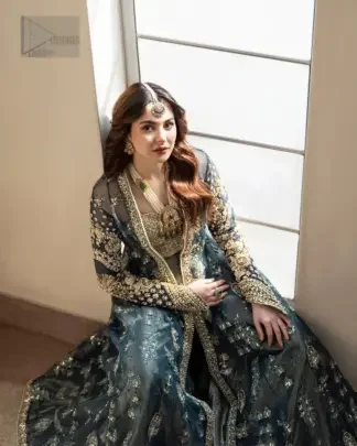 Turn heads at your event with our exceptional bridesmaid outfit, a true embodiment of individuality and style. This unique teal front open dress is a masterpiece of design, that is decorated with tilla, dabka, kora and Kundan capturing the essence of your special moment with unparalleled grace.