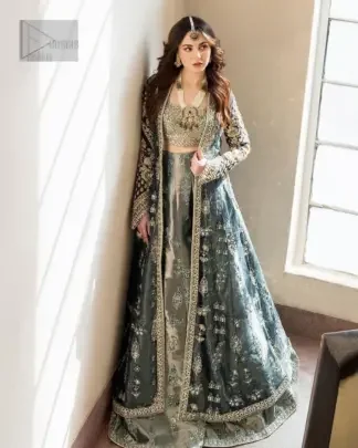 This unique teal front open dress is a masterpiece of design, that is decorated with tilla, dabka, kora and Kundan capturing the essence of your special moment with unparalleled grace.