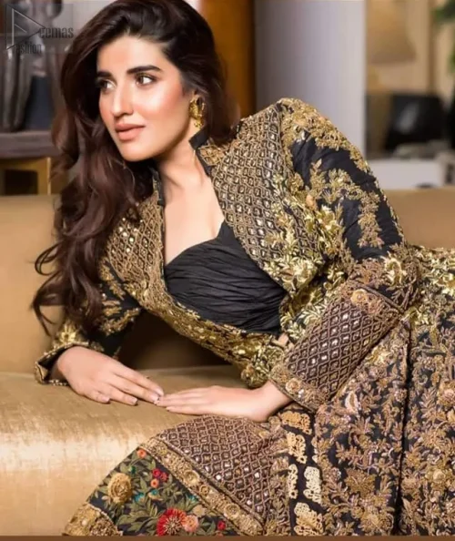 The rich black hue, enhanced by intricate antique embroidery and golden threadwork, creates an aura of mystery and refinement.