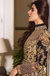 This ensemble is crafted from luxurious raw silk, this blouse pairs beautifully with pants for a complete ensemble that radiates opulence and grace.