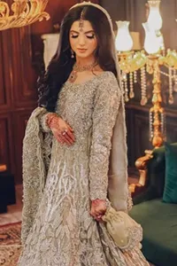 The scalloped edges of the dupatta add an enchanting detail, trailing behind you like a whisper of elegance. Adorned with delicate silver embroidery, the entire design glimmers with understated beauty.