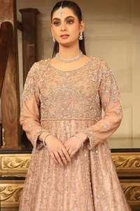 Radiate timeless beauty in the Fawn Flared Scalloped Maxi Can Can Lehenga, a creation designed for the bride who cherishes elegance and grandeur. The luxurious Katan Banarsi Jamawar fabric envelops you in opulence while the embellished bodice glimmers with intricate silver and golden embroidery.