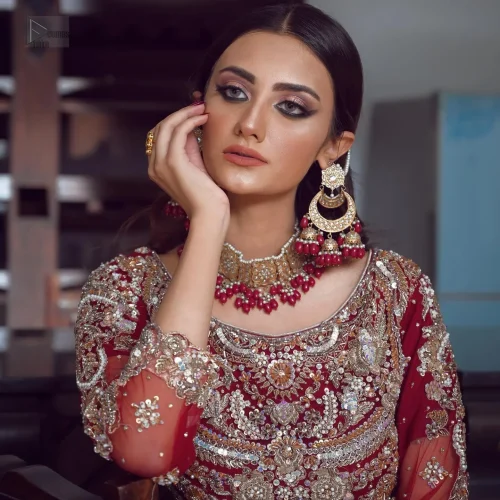 The blouse features a classic round neckline and elegant three-quarter sleeves, adding a touch of vintage charm. Intricate antique embroidery