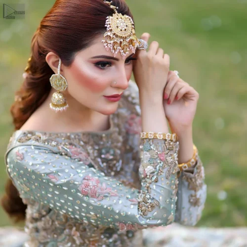 The blouse showcases a boat-shaped neckline and full sleeves, adding a touch of contemporary sophistication. Mint Green Lehenga Blouse -