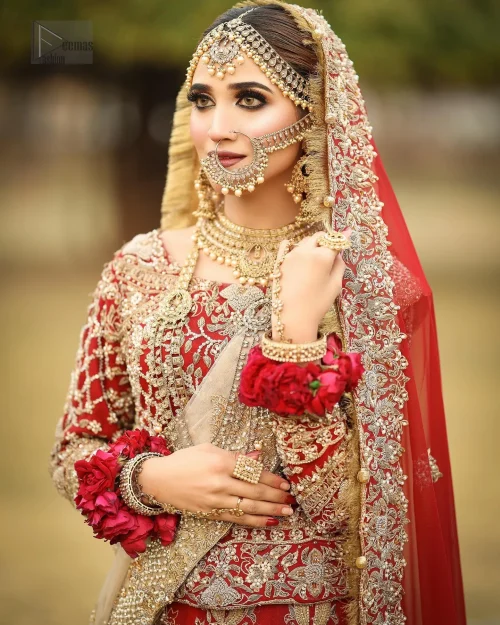 Exude splendour and charisma in this magnificent ensemble, an epitome of exquisite craftsmanship. The striking lehenga, enhanced by voluminous Can