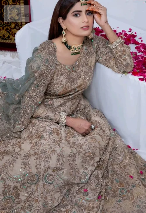 The full-length silhouette, adorned in soft, neutral beige, radiates timeless sophistication with effortless grace.