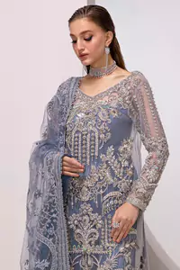 The shirt, with its full sleeves and V-neckline, is adorned with delicate silver & golden embroidery, creating a harmonious blend of tradition and luxury.