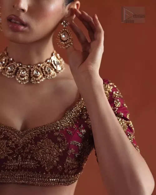 Sweetheart Neckline Detail: Detailed shot of the sophisticated sweetheart neckline adorned with light golden Dabka and stones.