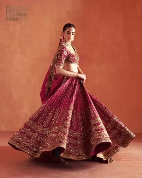 Hemline Craftsmanship: High-definition shot of the heavily embellished lehenga hemline with light golden silk threads.
