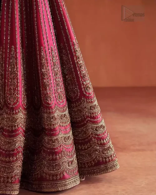 Geometric Lehenga Patterns: A detailed shot of the unique geometric patterns embroidered across the crimson raw silk lehenga.