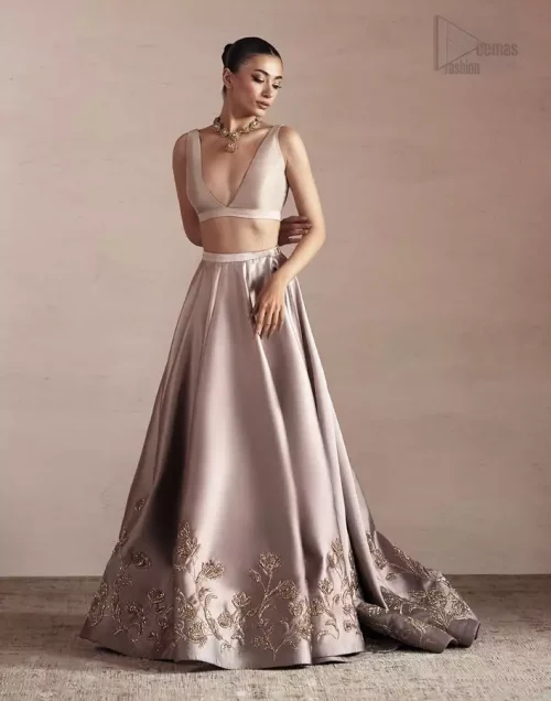 Oyster pink silk lehenga with delicate golden embroidery.