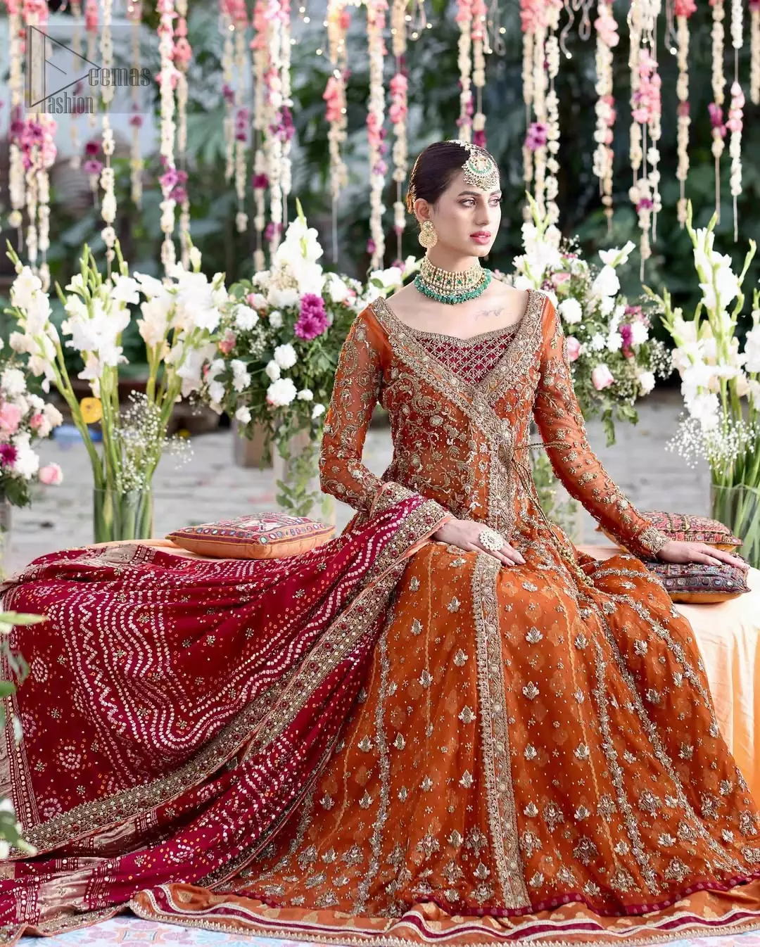 The attire’s full sleeves and a sweetheart neckline shape femininity with quiet strength, while an organza dupatta in deep red wraps the look in warmth and allure.