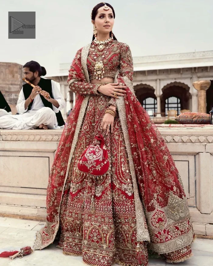 Make your day bright and bold! Deemas Fashion presents a beautiful red outfit which involves silver embroidery and is covered with tilla, dabka, kora, Kundan and the beautiful details of Zardozi. The full sleeves are covered with attractive floral patterns. Further, the jewel neckline gives a romantic touch to this beautiful outfit. The?Bridal Lehenga?has a massive flare and it gives the gorgeous bride a breathtaking look on the big day.?The Lehenga is gracefully emblazoned with?sequins, crystals, and Resham. Intricate details of zardozi and gota make this Lehenga Dress an epitome of grace. A beautiful dupatta with floral patterns & beautiful embellished border completes the look. Top: Blouse Colour: Red Fabric: Organza Fully Embellished Jewel Neckline Silver Embroidery Full-Length Sleeves Floral Patterns Concealed With Side Zip Finished Edges Bottom: Lehenga Colour: Red Fabric: Organza Fully Embellished Flared Finished Edges Fixed Waist Belt With Side Zip Closure Dupatta: Colour: Red Fabric: Net Floral Patterns Dupatta Having Four Sides Embellished Border Finished Edges Embellishment : Work includes kora, dabka, stones, sequins, beads, silk threads and Swarovski crystals. 100% pure highest quality imported fabric.
