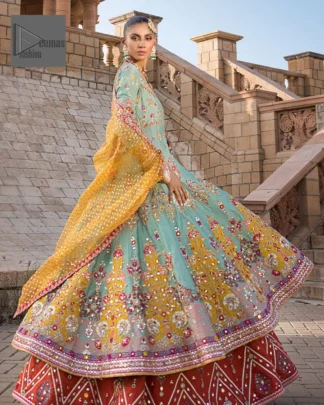 Effortlessly achieve the perfect bride look with this mehndi wear! Turquoise Frock is adorned with gorgeous motifs in multiple colors. It is further encrusted with the magic of gota, pitta, naqshi, Zardozi, tilla, and dabka along with sequins and pearls. The round neckline gives a traditional look to the outfit. Further, the tiny floral motifs also intensify the beauty of the masterpiece. This piece is paired up with an orange lehenga to make the contrast balance. Complete this outfit with a dupatta framed with four-sided borders to make your day versatile and charming.