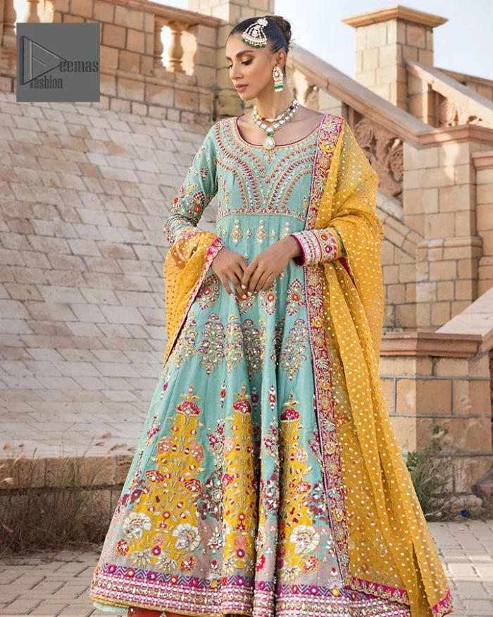 Effortlessly achieve the perfect bride look with this mehndi wear! Turquoise Frock is adorned with gorgeous motifs in multiple colors. It is further encrusted with the magic of gota, pitta, naqshi, Zardozi, tilla, and dabka along with sequins and pearls. The round neckline gives a traditional look to the outfit. Further, the tiny floral motifs also intensify the beauty of the masterpiece. This piece is paired up with an orange lehenga to make the contrast balance. Complete this outfit with a dupatta framed with four-sided borders to make your day versatile and charming.